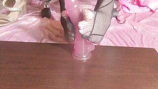 Cute feet in fishnets stroking pink dildo