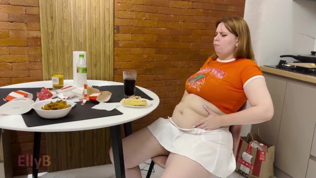 Cute girl overeating KFC. Big Belly Bloat. Painful Stomach