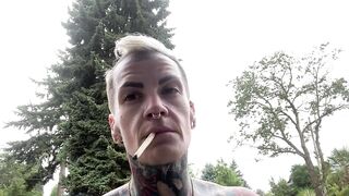 Butch dyke smokes and shaves head flexes muscles