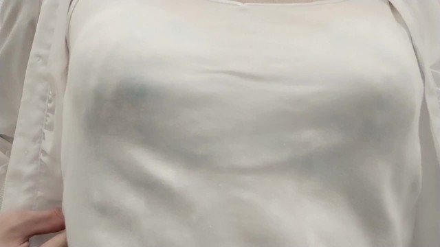 Crossdresser, light blue bra is seen through the camisole.