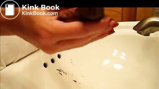 Curly girl shitting in the Sink