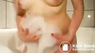 Young girl two floaters in bathtub