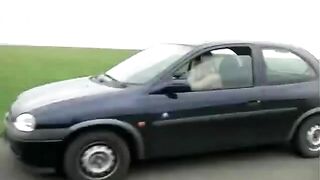 Girl shitting standing near the black car - Pooping and piss