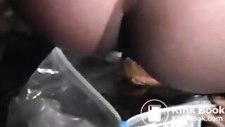 Black babe shitting in a bag outdoor