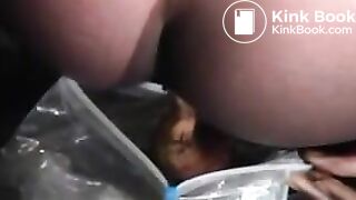 Black babe shitting in a bag outdoor