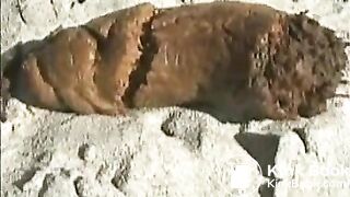 Babe pooping on a sandy beach