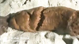 Babe pooping on a sandy beach