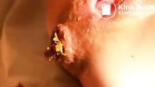 Blindfolded man licks off brown feces