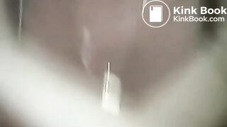 A girl in a white baseball cap pooping in the toilet - Webcam in the womens toilet