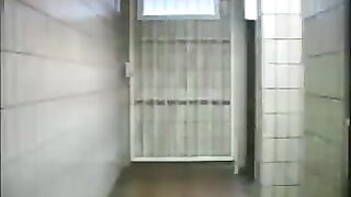Squirting enema in public toilet entrance