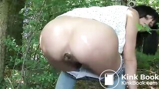 Brunette pooping in the woods