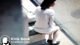 Woman Shitting At Bus Stop
