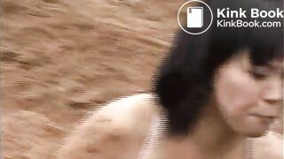 2 girls wrestling on manure field