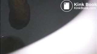 Woman shitting a long turd very slowly in the toilet