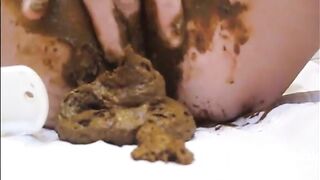 Mature lady masturbating with brush and shitting