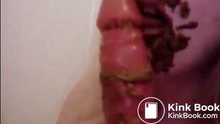 Dirty girl sucking and licking a shitty dildo