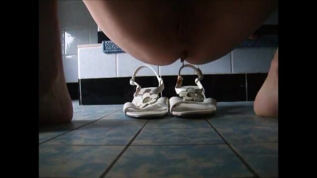 Girl shitting on sandals then wearing it
