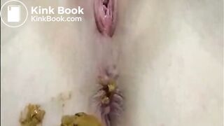 Shaved girl shitting closeup and fingering her pussy