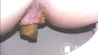 Woman shitting long turd in the toilet