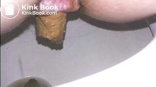Woman shitting long turd in the toilet