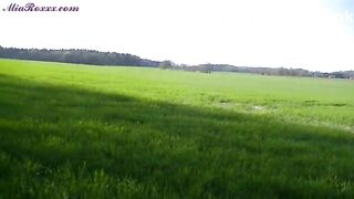 Mia pooping on the edge of a field