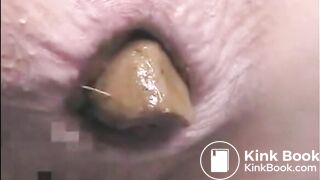 Girl shitting a very big turd closeup