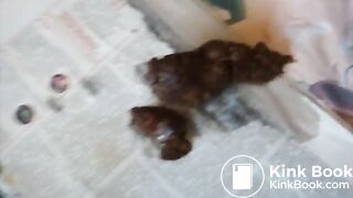 Slim brunette pushes out a meaty turd