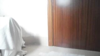 Slim shy girl poops into a plastic cup