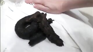 Very sexy brunette in high heels and lingerie shitting a black turd