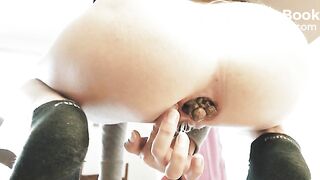 Fingering her asshole as the poop emerges