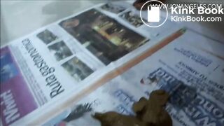 Naomi pooping on newspaper