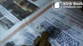 Naomi pooping on newspaper
