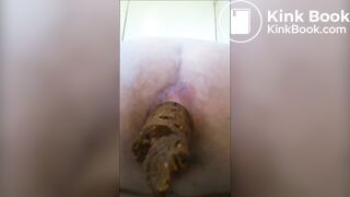Girl is shitting a very long turd closeup