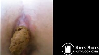 Girl is shitting a very long turd closeup
