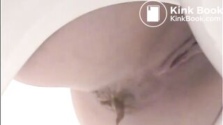 Girl shitting a lot in the toilet closeup