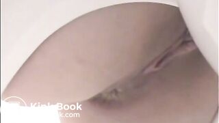 Girl shitting a lot in the toilet closeup