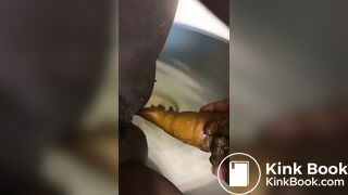 Ebony lady pushing pebbles into the toilet