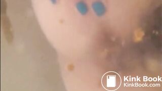 Woman shitting in the water of bathtub
