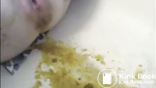 After enema woman shitting with power a lot in the bathtub