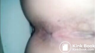 Girl shitting a dark turd in the toilet closeup