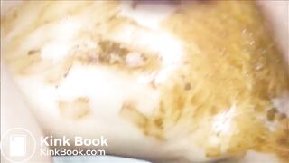 Woman masturbating with dildo and smearing shit