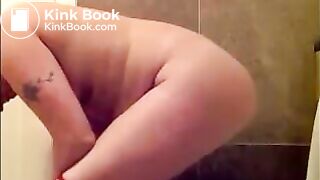 Woman shitting long turd on toilet standing