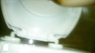 Woman shitting a long turd in the toilet