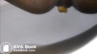 Ebony milf shitting closeup in the toilet