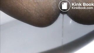 Ebony milf shitting closeup in the toilet