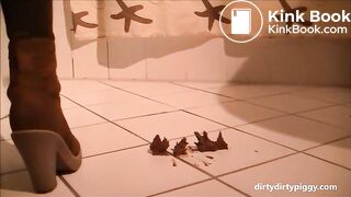 Girl shitting a very long turd on her hand standing