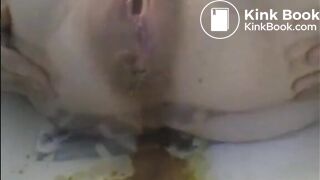 Woman shitting liquid after enema