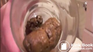 Skinny blonde girl shitting in a glass