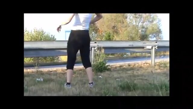 Girl shitting outdoor close to the road