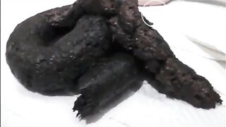 Sexy brunette in high heels and lingerie open wide legs and shitting on the floor